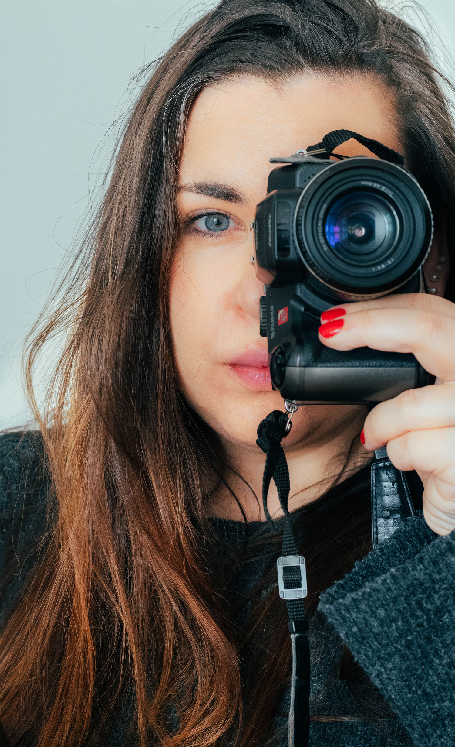 A photographer looking through her camera